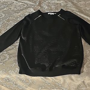 Black sweater with functional zippers at neckline